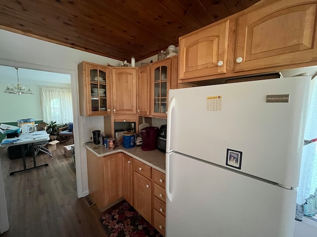 kitchen with dark hardwood / wood-style flooring, a notable chandelier, white refrigerator, pendant lighting, and wood ceiling