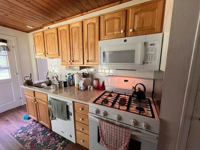 kitchen featuring white appliances, sink, tasteful backsplash, wood-type flooring, and wood ceiling