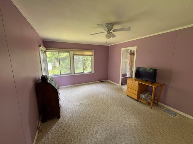 interior space featuring light colored carpet, ceiling fan, and crown molding