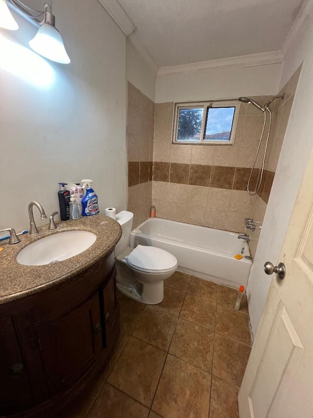 full bathroom featuring tiled shower / bath combo, tile patterned floors, crown molding, toilet, and vanity