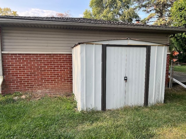 view of outdoor structure featuring a lawn