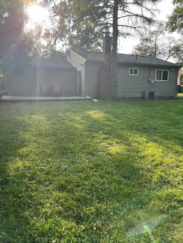 view of yard with central AC and a patio area