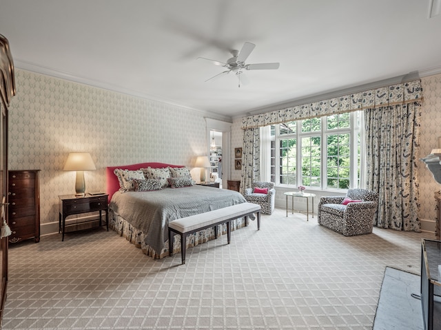 carpeted bedroom with ceiling fan and ornamental molding