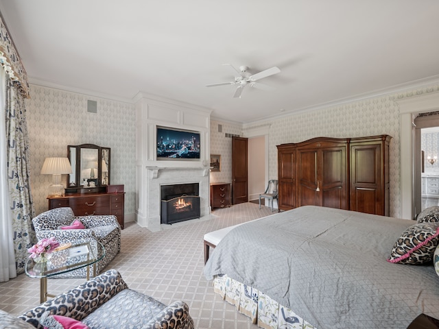 carpeted bedroom featuring ceiling fan and crown molding