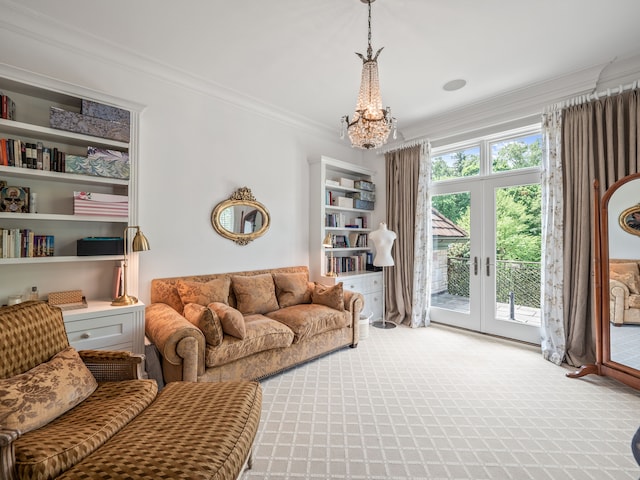 living room with a chandelier, french doors, carpet flooring, and crown molding