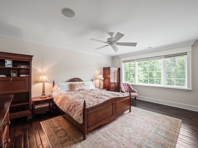 bedroom with ceiling fan, ornamental molding, and dark wood-type flooring