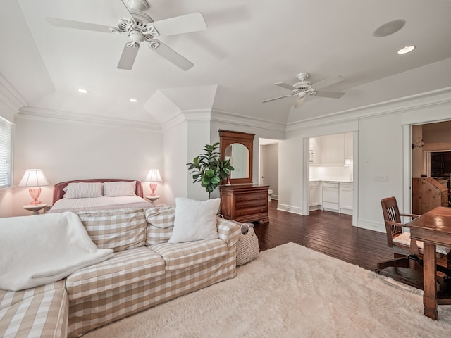 bedroom featuring dark hardwood / wood-style flooring, ensuite bathroom, ceiling fan, and crown molding