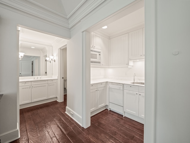 interior space featuring dark hardwood / wood-style flooring, ornamental molding, and sink