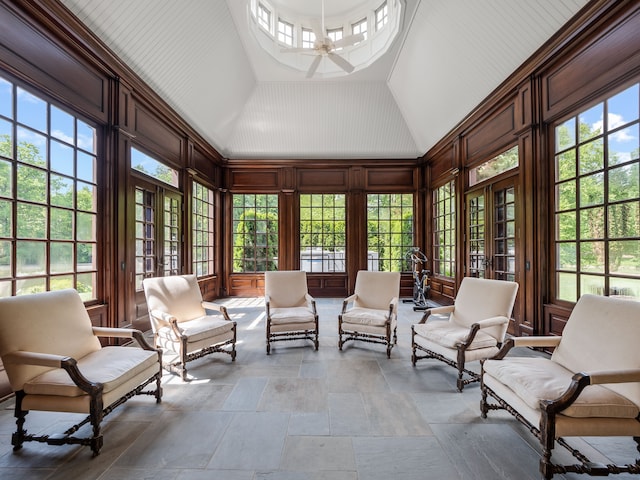 sunroom / solarium featuring ceiling fan, a healthy amount of sunlight, and lofted ceiling