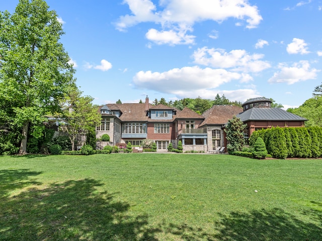 rear view of property with a yard