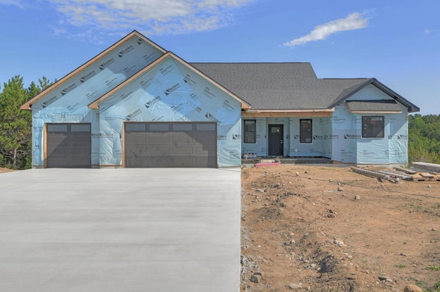 property in mid-construction featuring driveway and a garage