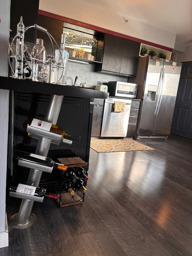 kitchen featuring wood-type flooring and stainless steel refrigerator with ice dispenser