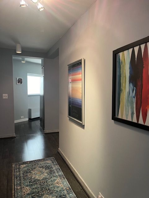 corridor featuring dark wood-type flooring