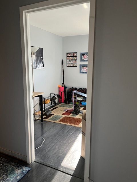 corridor featuring dark wood-type flooring