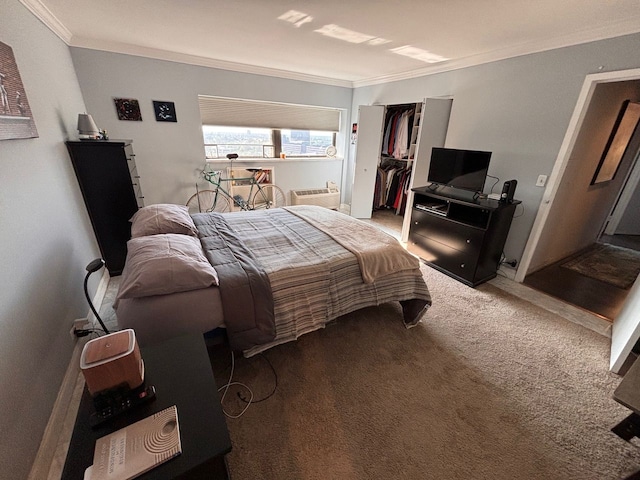 carpeted bedroom with crown molding and a closet