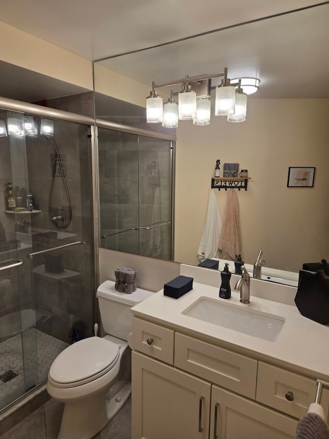 bathroom featuring vanity, toilet, and walk in shower