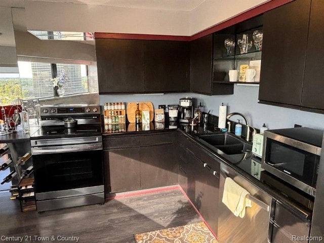 kitchen with dark hardwood / wood-style flooring, sink, dark brown cabinets, and appliances with stainless steel finishes