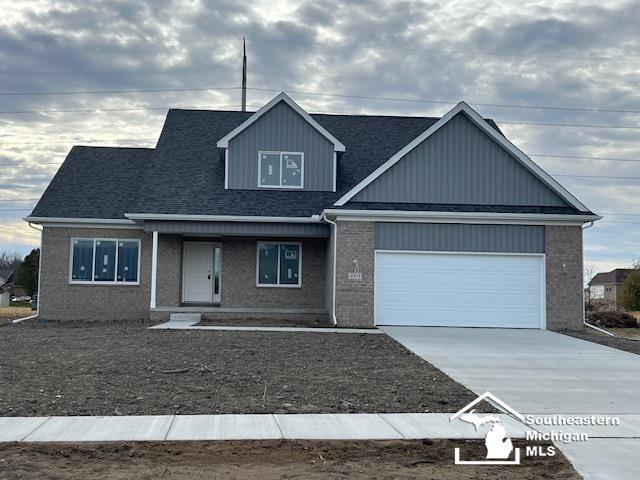 view of front of property with a porch and a garage