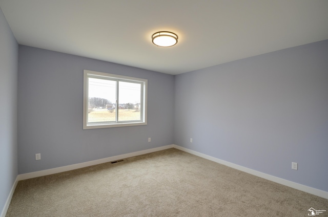 4911 Skylark Dr, Monroe, MI 48161 - spare room featuring carpet floors, baseboards, and visible vents