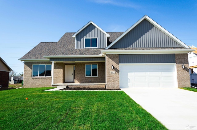4911 Skylark Dr, Monroe, MI 48161 - view of front facade featuring brick siding, an attached garage, and board and batten siding