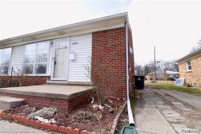 2439 Stieber St, Westland, MI 48186 - view of exterior entry featuring concrete driveway and brick siding