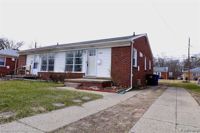 2439 Stieber St, Westland, MI 48186 - view of front of house featuring brick siding, driveway, and a front lawn