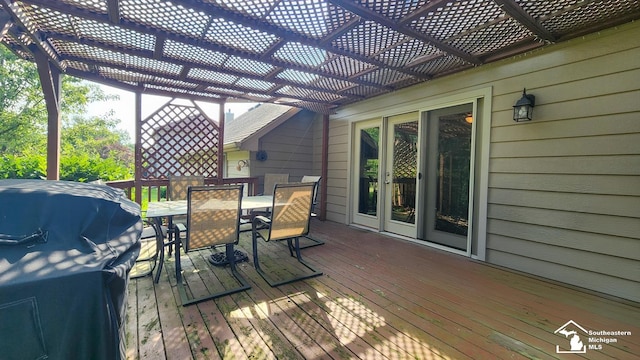 wooden deck with a pergola and grilling area