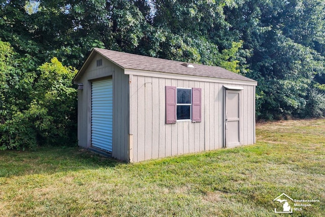 view of outbuilding with a lawn