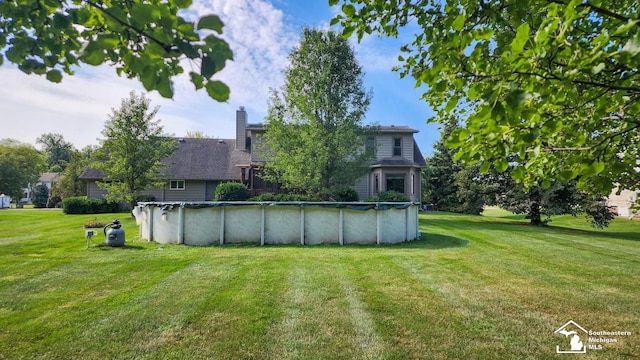 view of yard featuring a covered pool