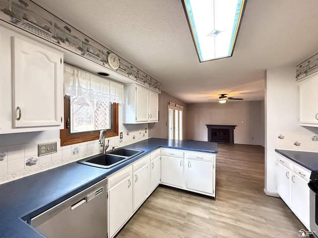 kitchen with dishwasher, white cabinetry, ceiling fan, and sink