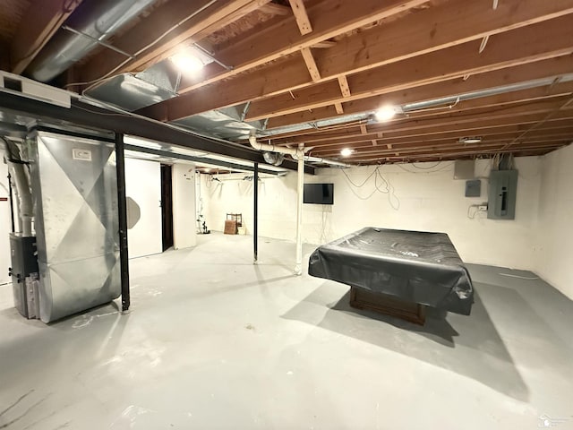 basement with electric panel, heating unit, and pool table