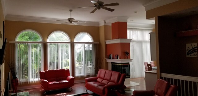 48280 Elmwood Dr, Shelby Twp, MI 48315 - living room featuring a ceiling fan, a multi sided fireplace, and crown molding