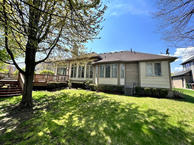 48280 Elmwood Dr, Shelby Twp, MI 48315 - rear view of property featuring a deck, central air condition unit, a lawn, a chimney, and brick siding