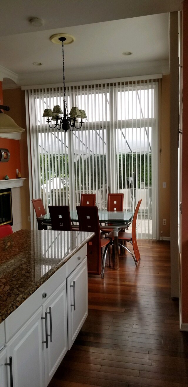 48280 Elmwood Dr, Shelby Twp, MI 48315 - dining space featuring a chandelier and dark wood-style floors
