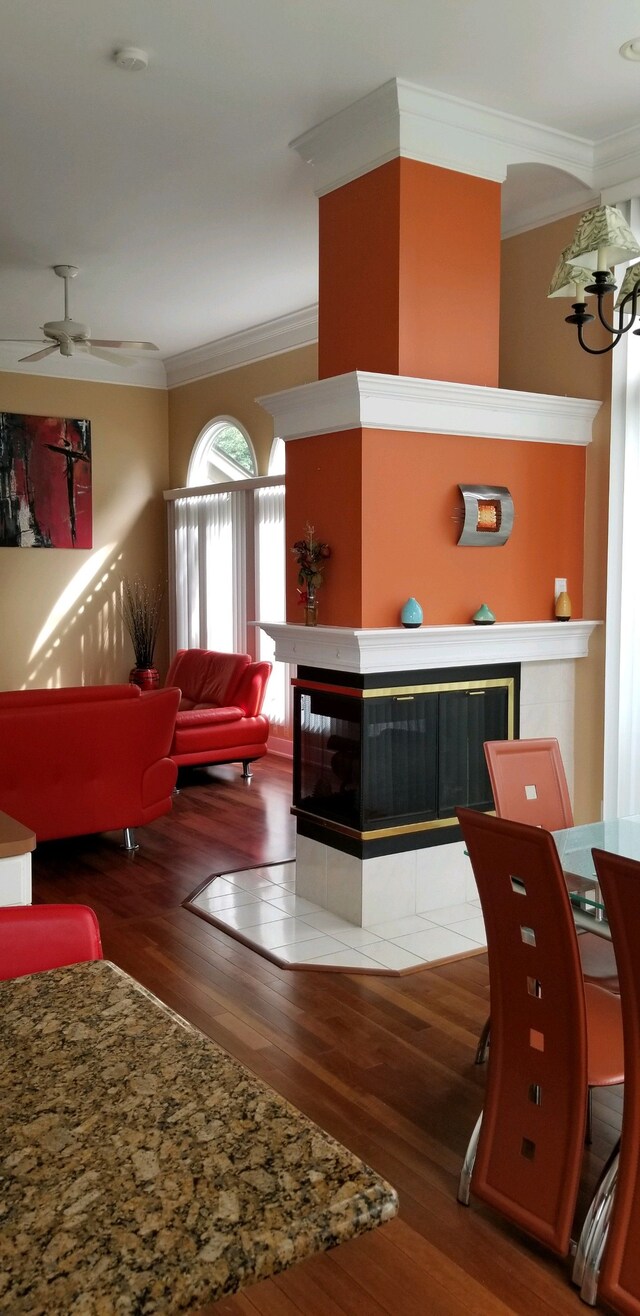 48280 Elmwood Dr, Shelby Twp, MI 48315 - kitchen with a fireplace, crown molding, wood finished floors, and a ceiling fan
