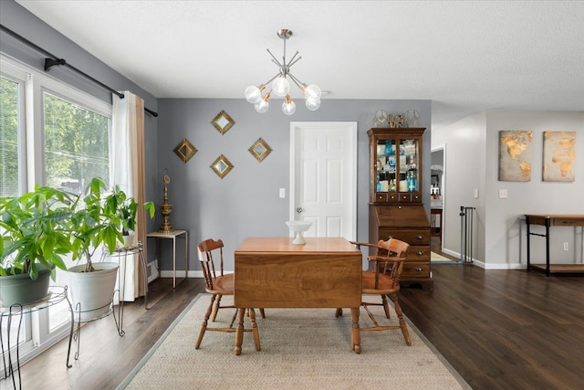 25217 King Rd, Romulus, MI 48174 - dining space with wood finished floors, a chandelier, and baseboards