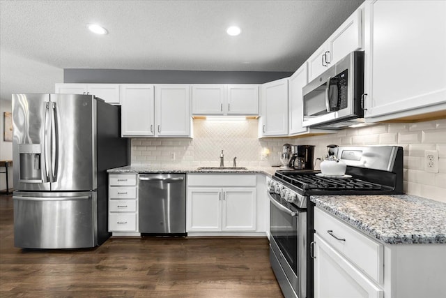 25217 King Rd, Romulus, MI 48174 - kitchen featuring stainless steel appliances, a sink, white cabinets, light stone countertops, and backsplash