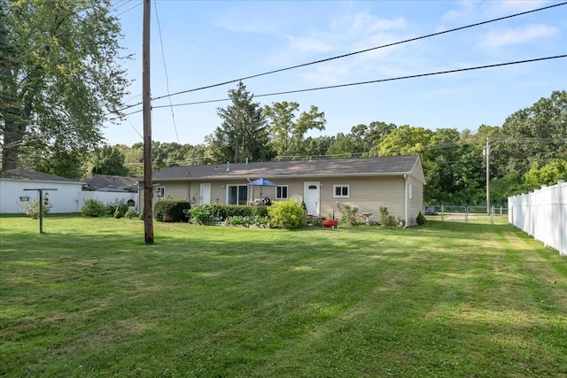 back of house featuring a yard