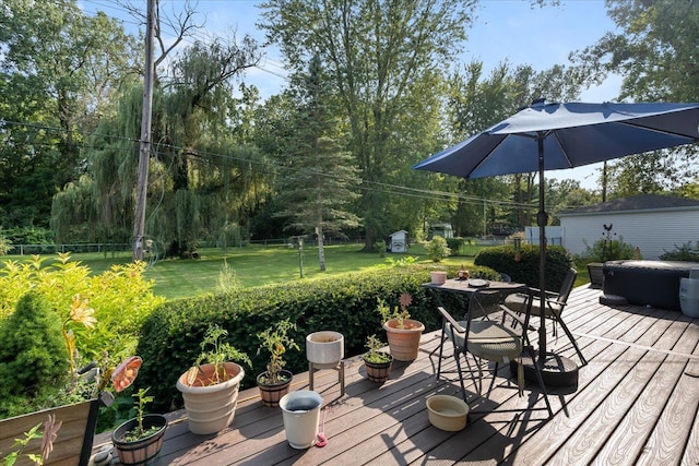 wooden deck featuring a yard