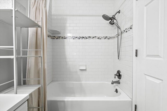 bathroom with vanity and tiled shower / bath