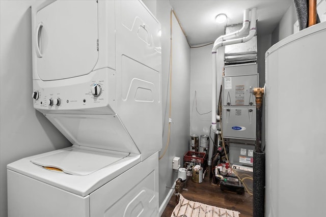 25217 King Rd, Romulus, MI 48174 - laundry area featuring stacked washing machine and dryer and wood finished floors