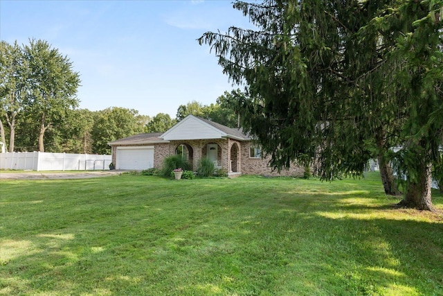 view of front of property featuring a garage and a front lawn