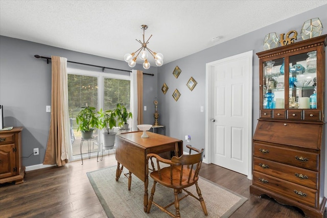 25217 King Rd, Romulus, MI 48174 - dining space with dark wood-style floors, a chandelier, baseboards, and a textured ceiling