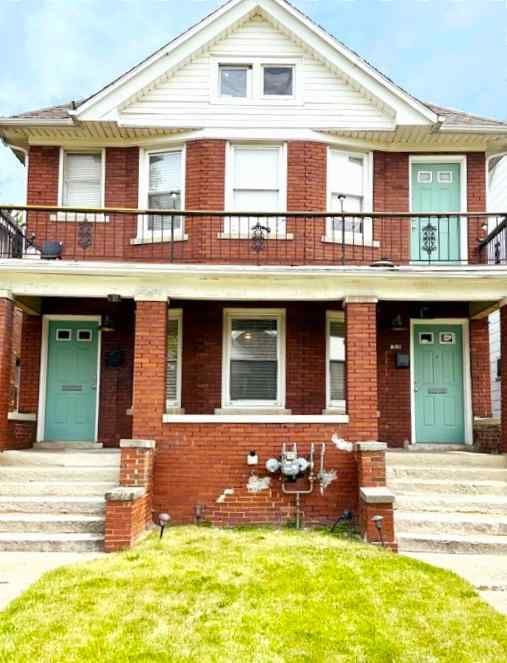 view of property featuring a porch and a front yard