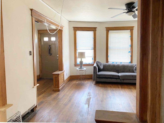 foyer entrance with dark hardwood / wood-style floors and ceiling fan