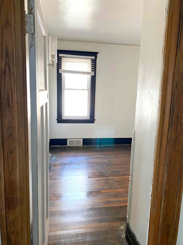 spare room featuring dark wood-type flooring