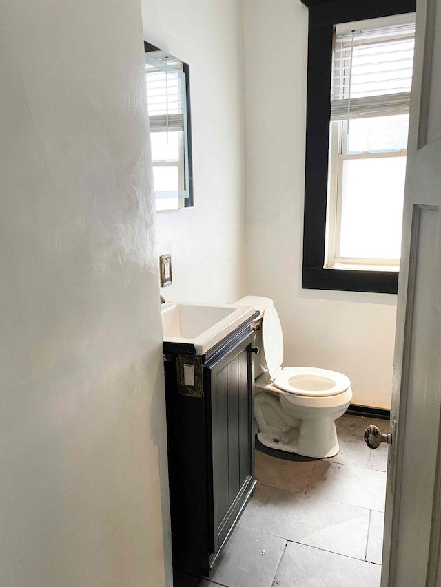 bathroom with tile patterned floors, vanity, and toilet