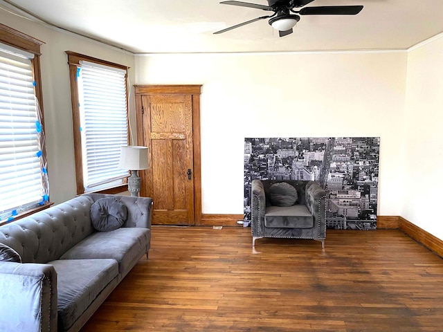 living room featuring dark wood-type flooring and ornamental molding