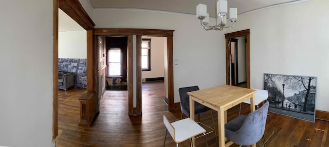 dining room featuring dark hardwood / wood-style flooring and a notable chandelier