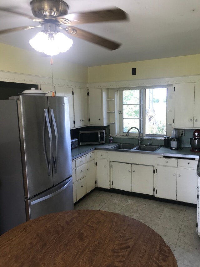 8620 Scio Church Rd, Ann Arbor, MI 48103 - kitchen with appliances with stainless steel finishes, a sink, a ceiling fan, dark countertops, and light tile patterned floors
